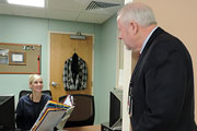 Mr. Devansky talks to employee Ms. Dianne Jacobs, Medical Support Assistant.