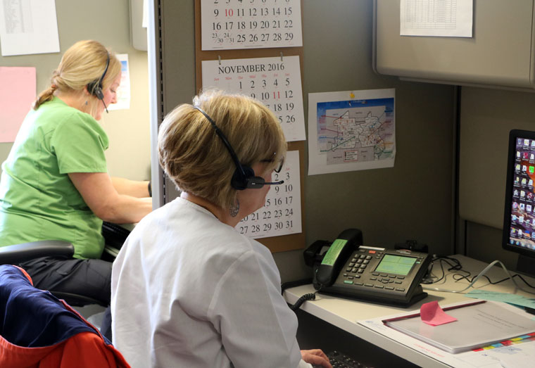 Registered nurses respond to phone calls in the triage call center.