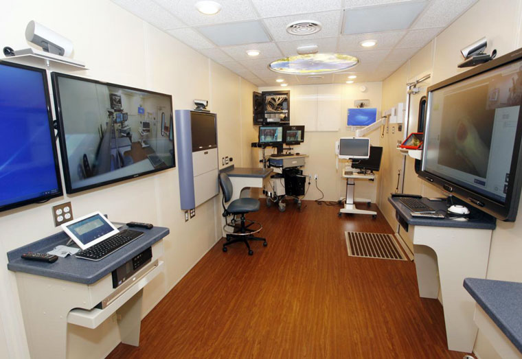 Inside the Telehealth Education Delivered mobile van with various stations of telehealth equipment on display.