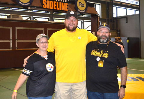 Two veterans posing for a photo with a Steelers player.