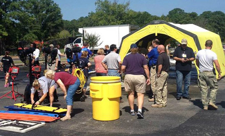 Emergency preparedness class participants set up for a mass casualty exercise.