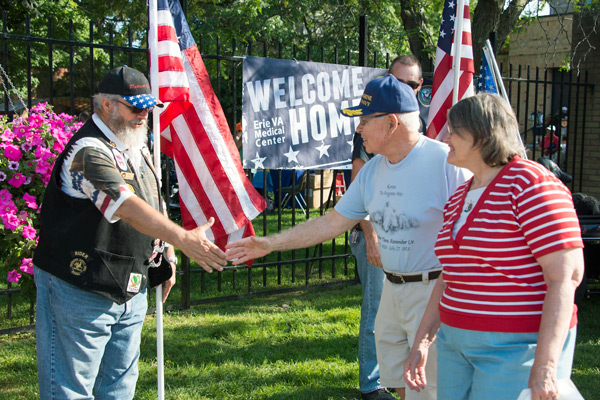 Veterans shaking hands at the welcome home event.