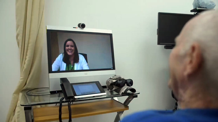 A Veteran interacts with a primary care provider through the telehealth equipment.