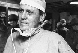 Old black and white photo of Dr. Starzl in the operating room following a transplant.