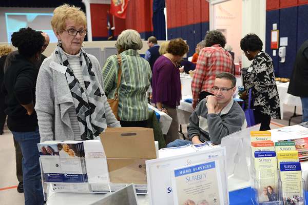 A woman browses through the exhibit tables at the caregiver conference.