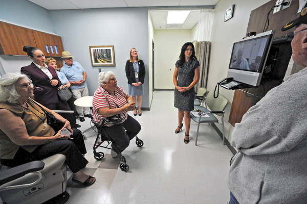 Guests tour the new clinic and test the video conference equipment.