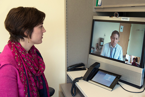 A clinician interacts with a patient during a telehealth session.