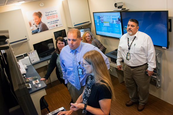 Iron Bow Solutions staff shows Erie VA Medical Center staff the new telehealth technology available in the T.E.D. van.