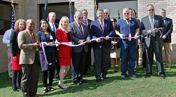 VA officials, leadership and other dignitaries cut the ribbon for the new behavioral health building.